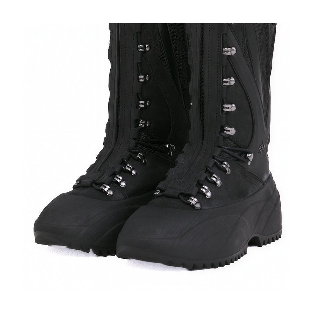 A pair of black tactical combat boots with silver metal eyelets and laces, shown from a three-quarters angle on a white background.